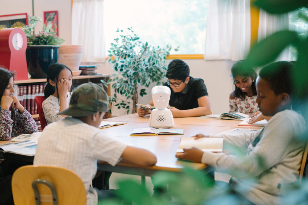 An AV1 robot in a classroom with students